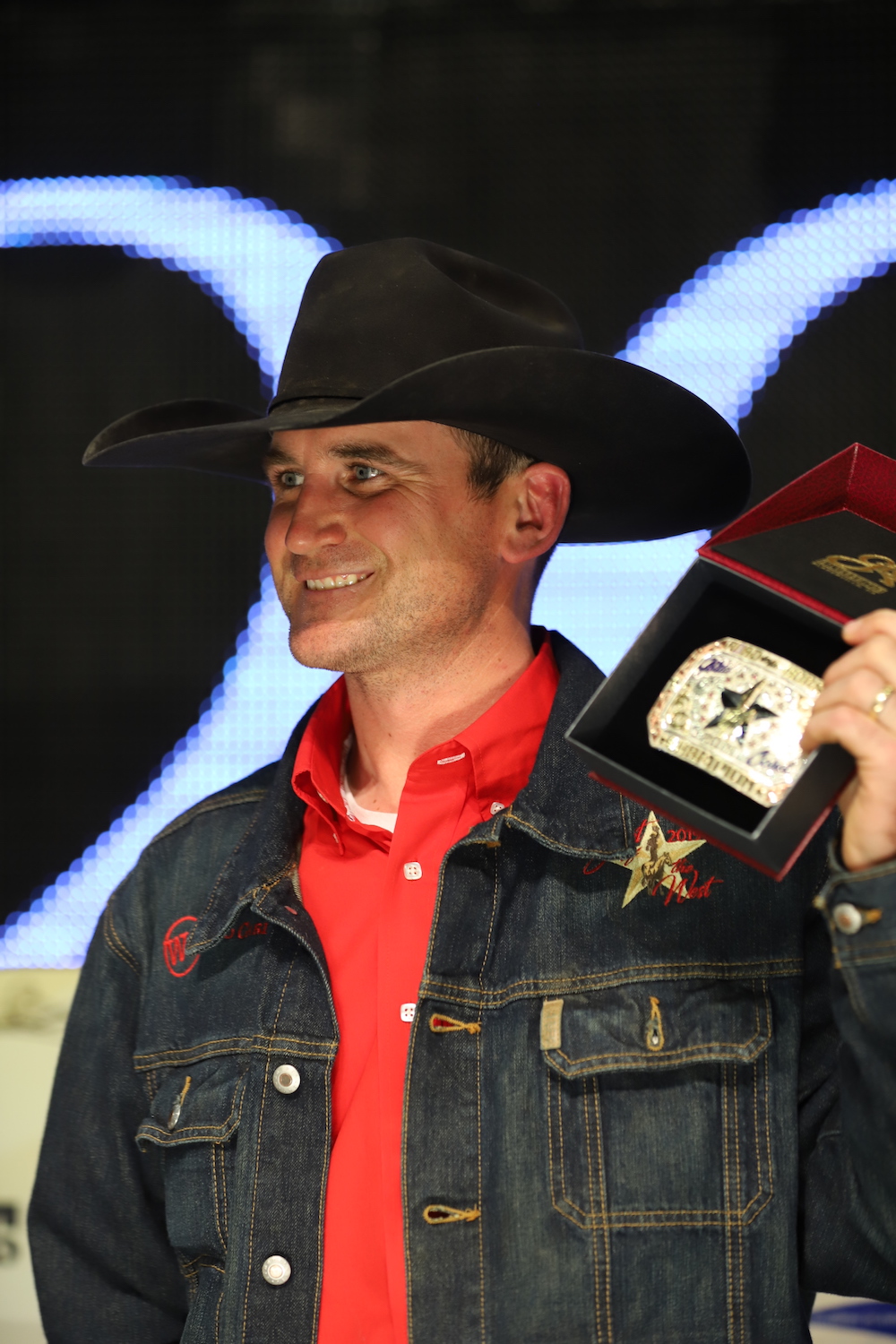 Wade Black standing on stage with buckle 